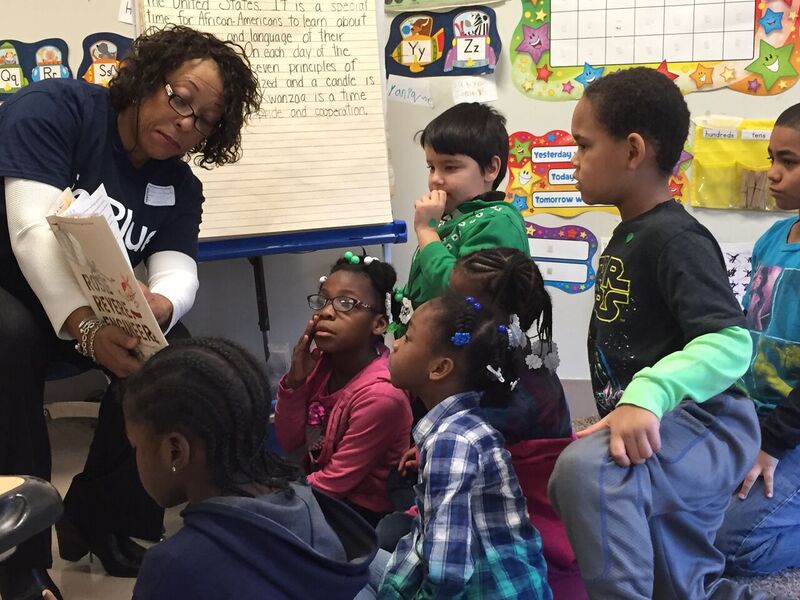 Over 100 first and second graders gathered around JetBlue crewmembers for a book reading of Rosie Revere, Engineer